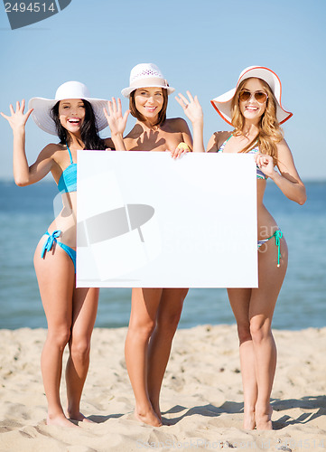 Image of girls with blank board on the beach