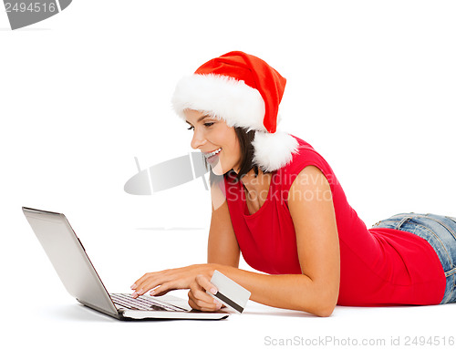 Image of woman in santa hat with laptop and credit card