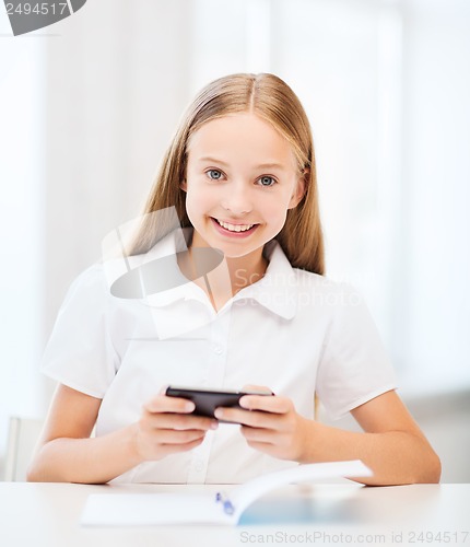 Image of girl with smartphone at school