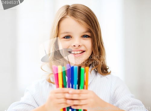 Image of girl showing colorful felt-tip pens