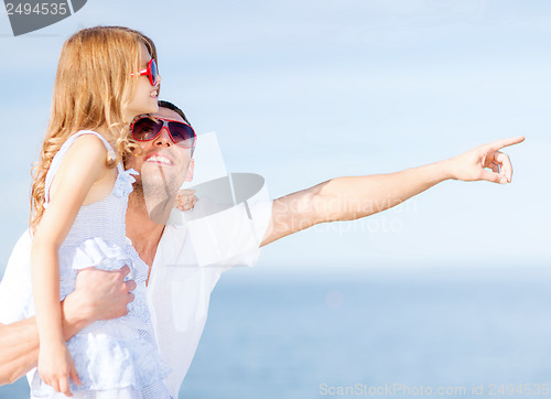 Image of happy father and child in sunglasses over blue sky