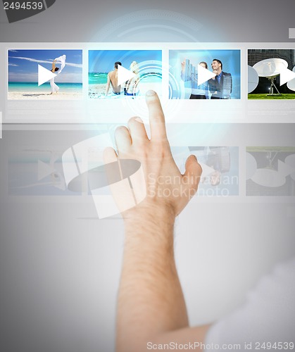 Image of man pressing button on virtual screen