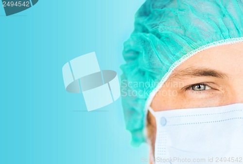 Image of surgeon in medical cap and mask