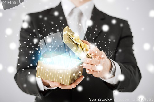 Image of man opening gift box