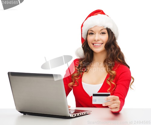 Image of santa helper woman with laptop and credit card