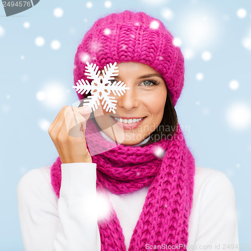 Image of woman in hat and muffler with big snowflake