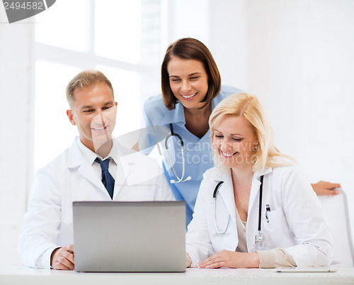 Image of group of doctors looking at tablet pc