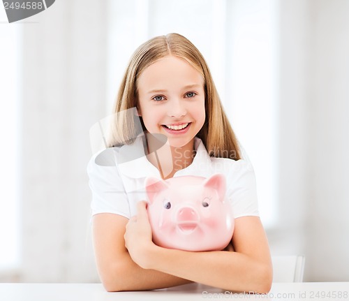 Image of child with piggy bank