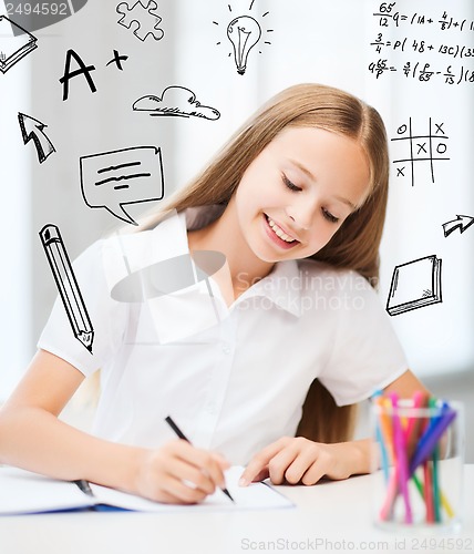 Image of little student girl drawing at school