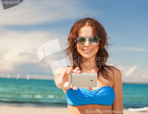 Image of woman in bikini and sunglasses