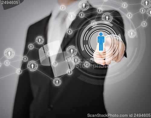 Image of businessman pressing button with contact