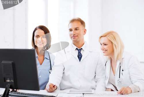 Image of doctors looking at computer on meeting