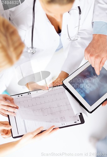 Image of group of doctors looking at x-ray on tablet pc