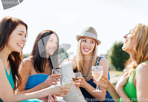 Image of girls with champagne glasses on boat