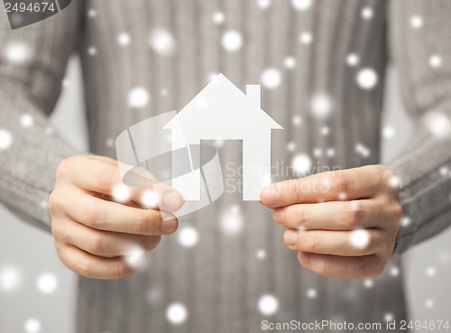 Image of man holding paper house