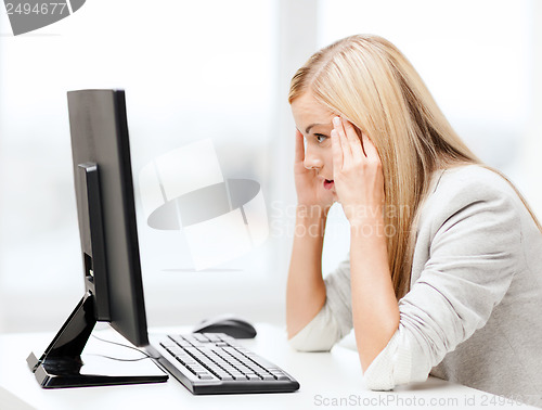 Image of stressed woman with computer