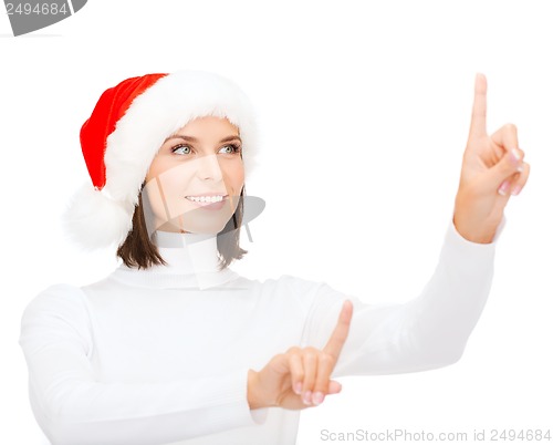 Image of woman in santa helper hat pressing vitrual button