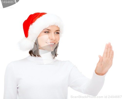 Image of woman in santa helper hat pressing vitrual button