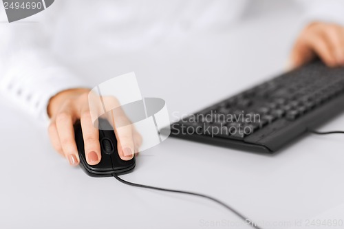 Image of woman hands with keyboard and mouse