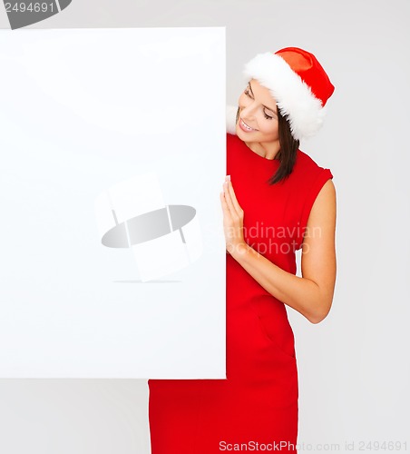 Image of woman in santa helper hat with blank white board