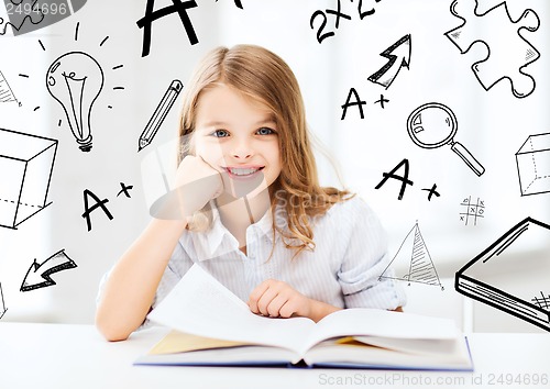 Image of little student girl studying at school