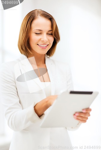 Image of businesswoman with tablet pc in office