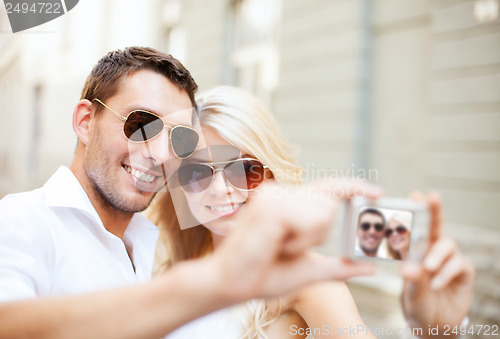 Image of couple taking photo in cafe