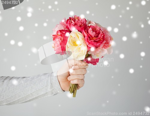 Image of man holding bouquet of flowers