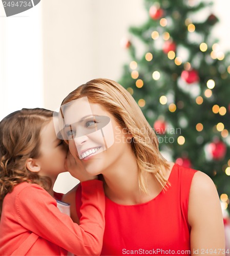Image of mother and daughter whispering gossip