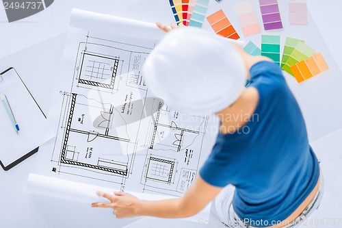 Image of woman with color samples and blueprint