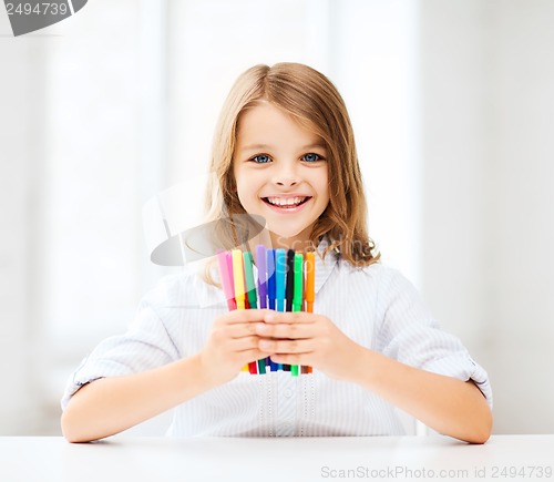 Image of girl showing colorful felt-tip pens