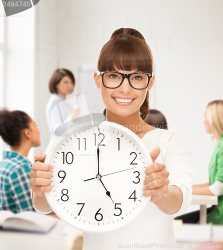 Image of student showing clock