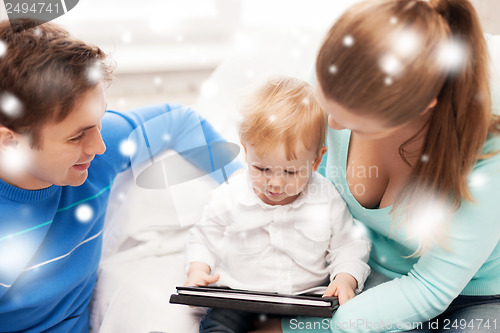 Image of parents and adorable baby with tablet pc