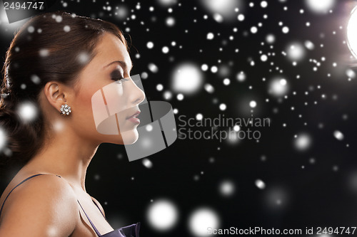 Image of woman in evening dress wearing diamond earrings