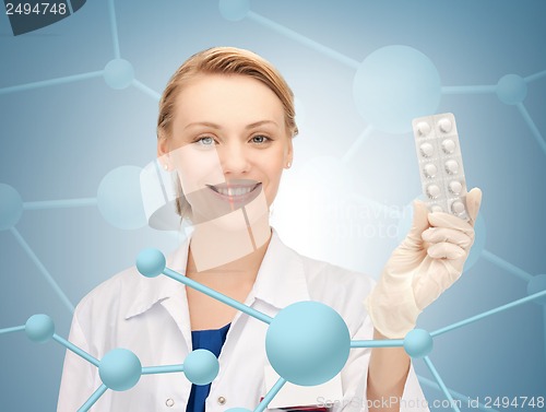 Image of attractive female doctor with pills