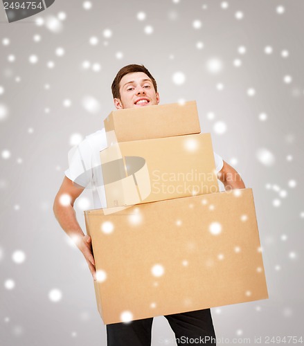 Image of young man carrying carton boxes