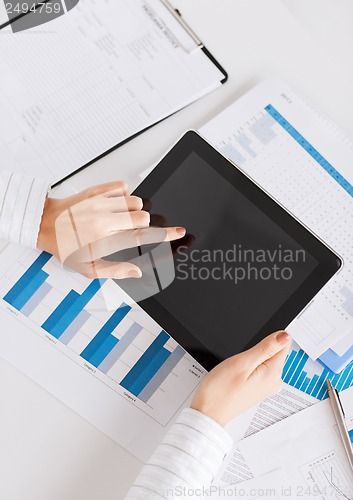 Image of woman with tablet pc and chart papers