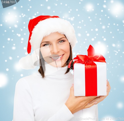 Image of smiling woman in santa helper hat with gift box