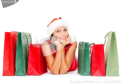 Image of woman in red shirt with shopping bags