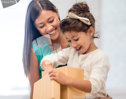 Image of happy mother and child girl with gift box