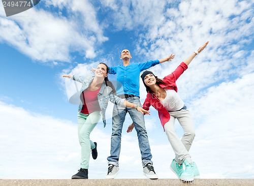 Image of group of teenagers spreading hands