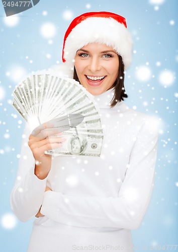 Image of woman in santa helper hat with us dollar money