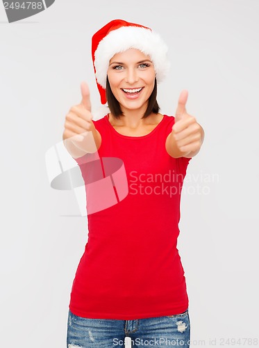 Image of woman in santa helper hat showing thumbs up