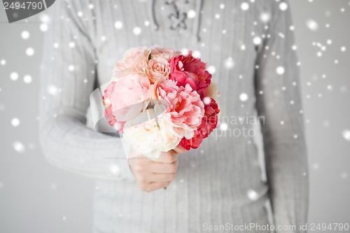 Image of man holding bouquet of flowers