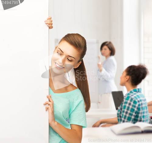 Image of smiling student girl with white blank board