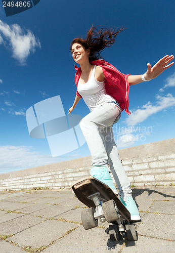 Image of teenage girl skating outside