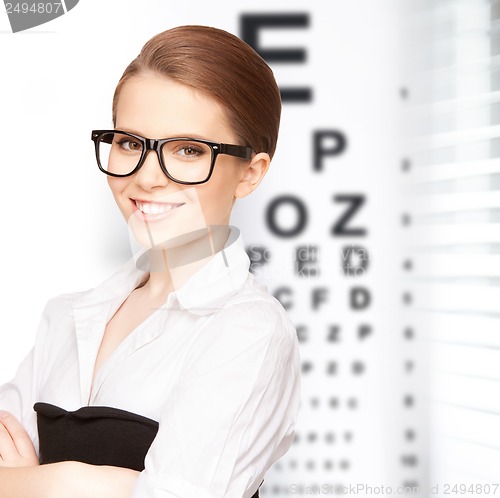 Image of woman in eyeglasses with eye chart