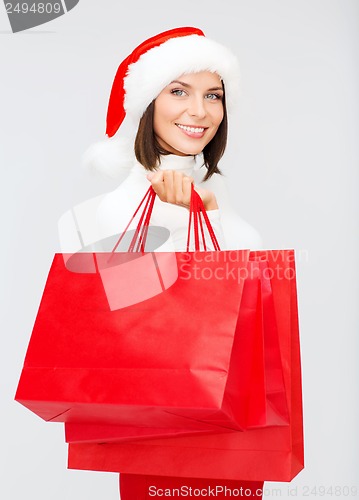 Image of woman in santa helper hat with shopping bags