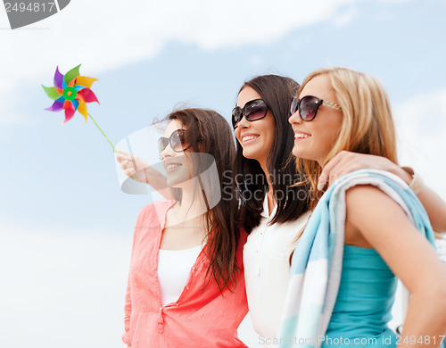 Image of girls with windmill toy on the beach
