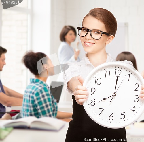 Image of student showing clock